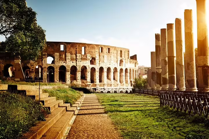 Sunset view of the Colosseum and Roman Forum ruins in Rome, Italy, featured on full-day fast track guided tour
