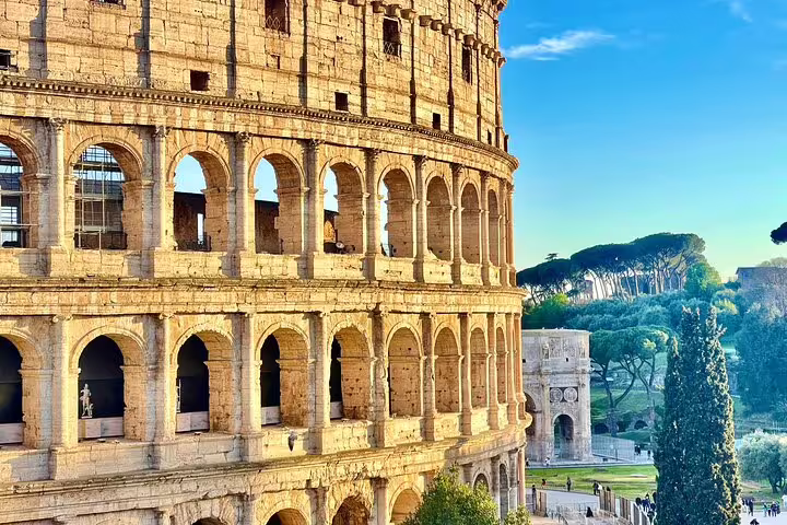 Morning view of the Colosseum in Rome with arches glowing in sunlight, a highlight of the Civitavecchia round-trip tour