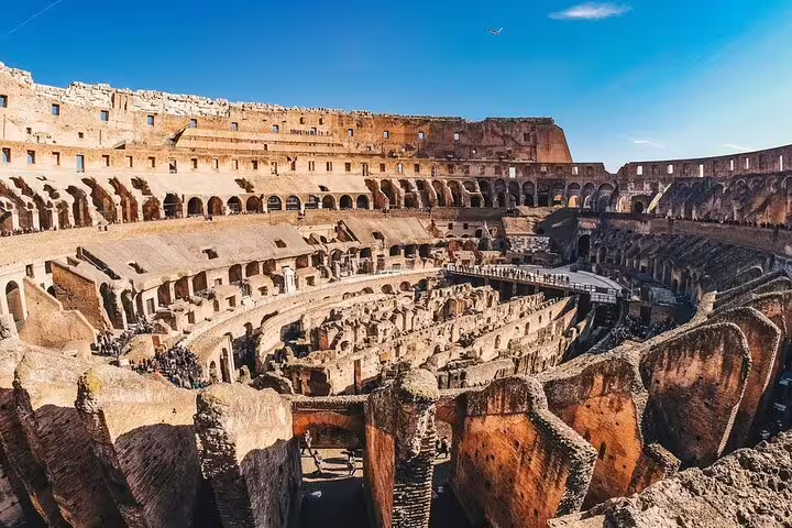 Panoramic interior view of the Colosseum in Rome on a sunny day, included in fast track guided tour with arena access