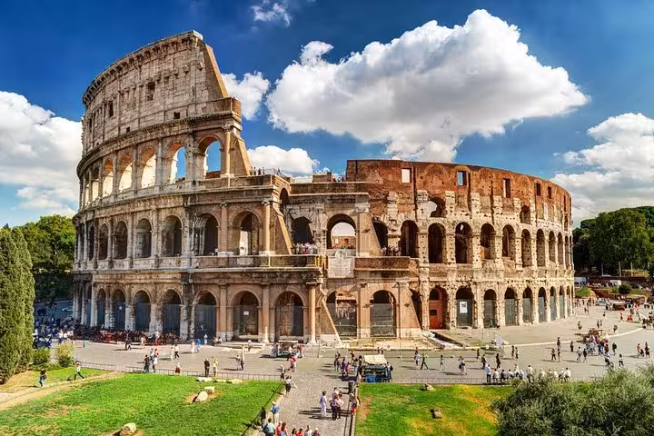 Stunning view of the Colosseum in Rome under a bright blue sky, a highlight of our private shore excursion from Civitavecchia.