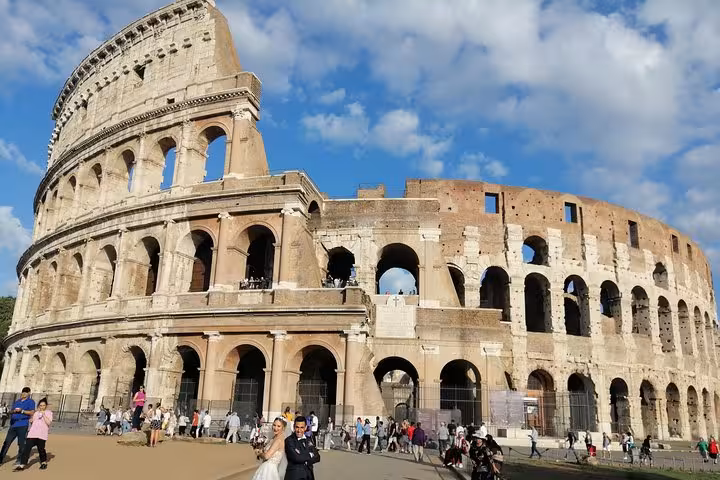 The majestic Colosseum under a blue sky, perfect for exploring with a Rome private tour guide.