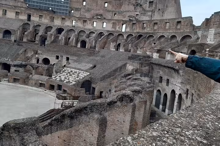 Explore the Colosseum's ancient architecture on a guided underground tour, showcasing its intricate interior arches.