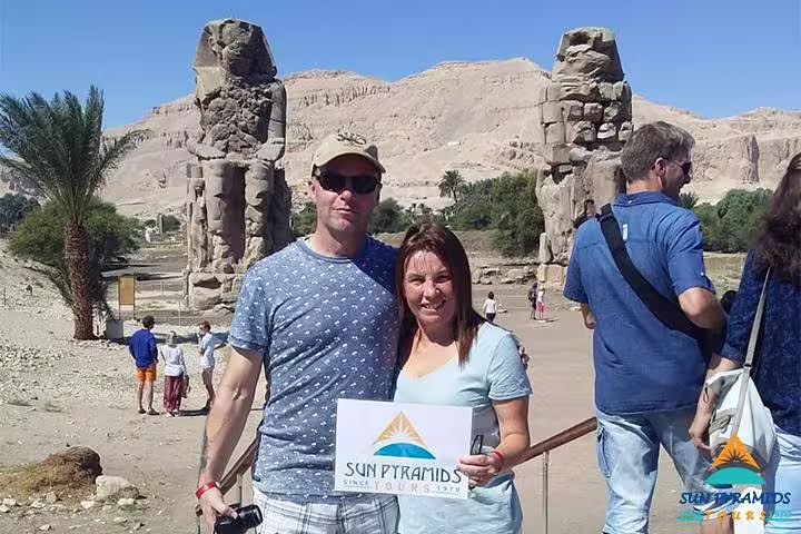 Tourists at Colossi of Memnon, Luxor West Bank, on 15-day Egypt itinerary to Pyramids, Aswan and desert oasis