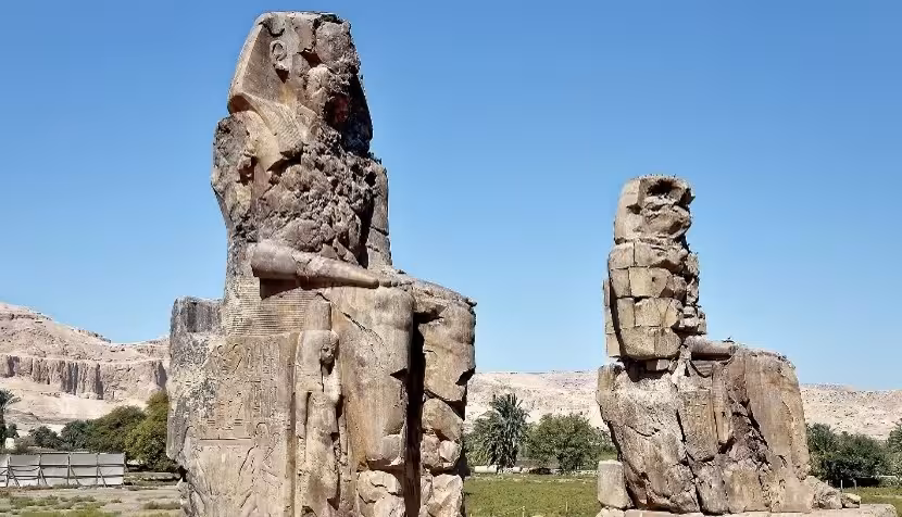 Colossi of Memnon twin ancient Egyptian statues near Valley of the Kings, Luxor