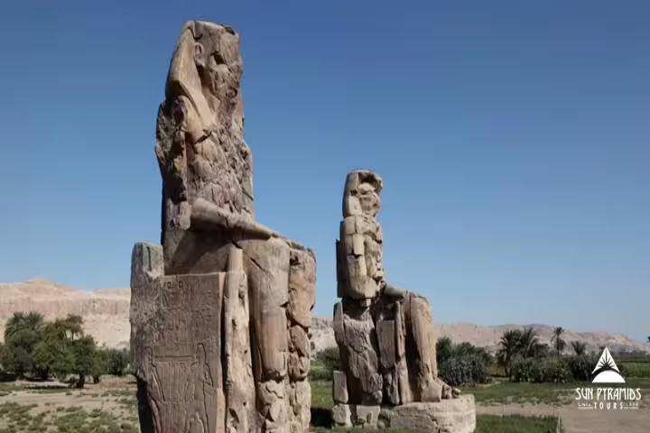 Colossi of Memnon statues in Luxor West Bank under clear sky, highlight of a 3-day Luxor city break package