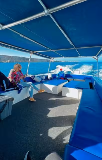 Shaded speedboat deck cruising to Comino Blue Lagoon at sunset, Malta tour to Crystal Lagoon and sea caves