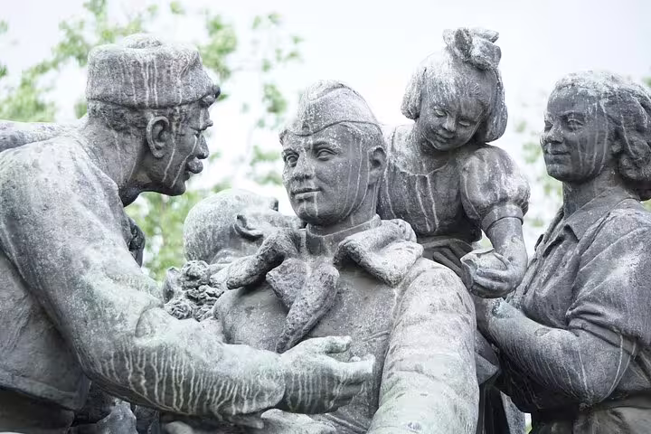 Soviet-era bronze statue group depicting a soldier welcomed by family, Sofia communist monument