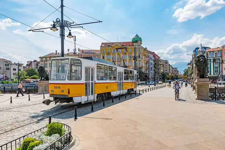 Yellow tram 3016 passing through a historic boulevard in Sofia, Bulgaria on a sunny day