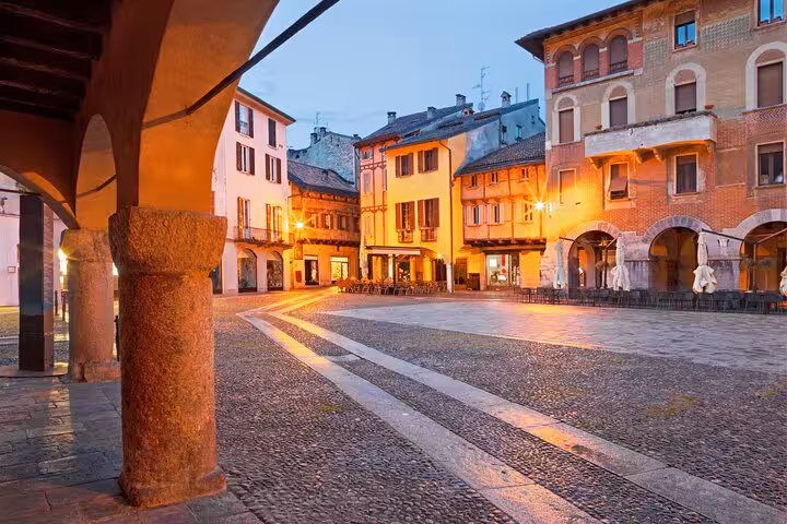 Evening view of Como historic piazza with arcades, Lake Como and Bellagio day tour from Milan