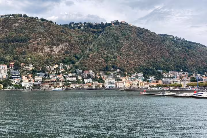 Como lakeside skyline and hillside villas seen from Lake Como boat cruise on Lugano to Como and Bellagio tour