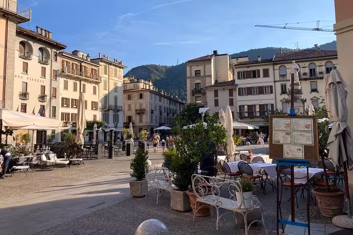Como old town piazza cafes and historic buildings on Lugano to Como Bellagio cruise and train day tour