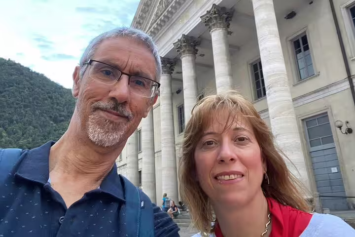 Couple smiling in front of neoclassical columns in Como, Italy