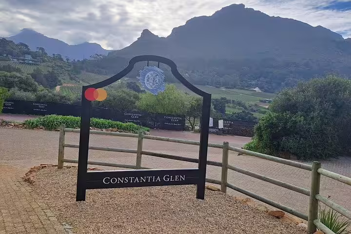 Constantia Glen entrance sign with mountainous backdrop, inviting you to explore Cape Town's exclusive wine region.