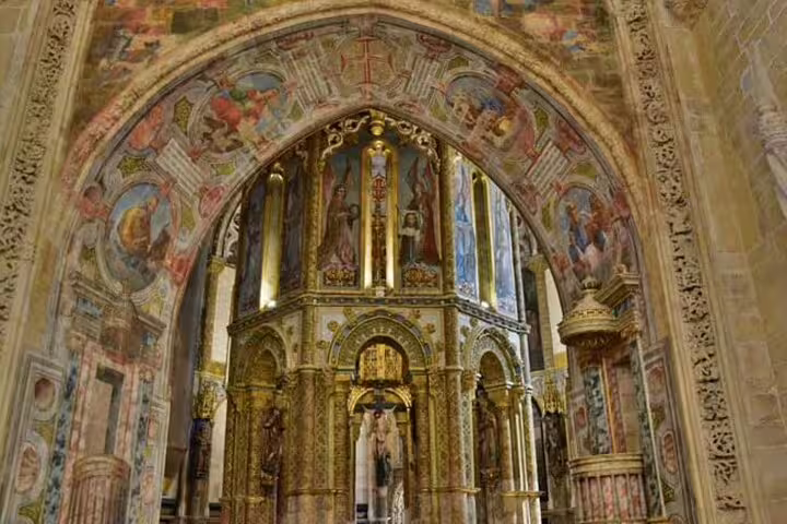 Intricate medieval architecture at the Convent of Christ in Tomar, Portugal, showcasing historic frescoes and ornate design.