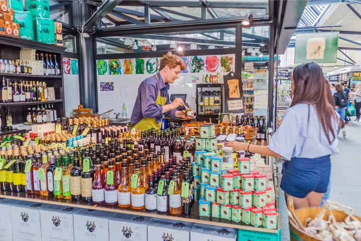 A vibrant Copenhagen market stall offers a variety of Scandinavian food and drinks, perfect for a private tasting tour experience.