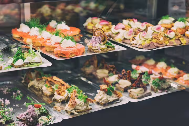 Assortment of colorful Scandinavian smørrebrød with fresh toppings, featured on a Copenhagen food and drink private tour.