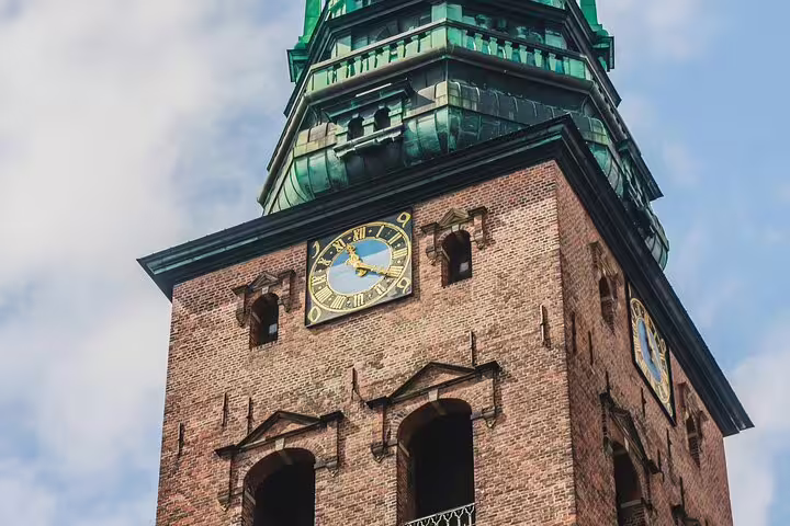 Explore the architectural beauty of Copenhagen with a private walking tour highlighting the iconic brick tower and clock.