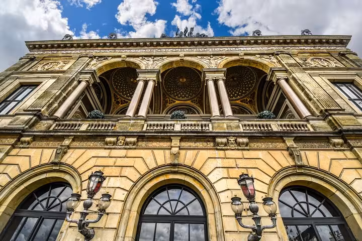 Ornate Neo-Baroque facade with arched windows and vintage lanterns in Copenhagen