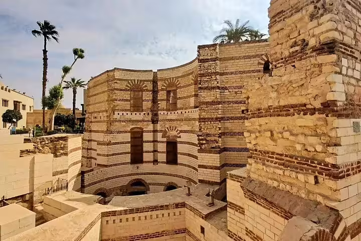 Ancient striped brick church ruins in Coptic Cairo, historic site visited on Cairo Citadel and Khan El-Khalili tour
