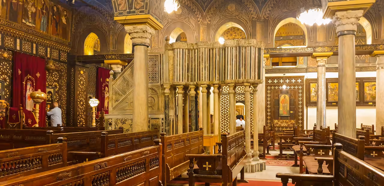 Coptic Cairo church interior with carved wooden pews and icons on 11-day budget Egypt tour with fees included