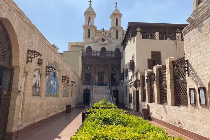 Sunlit courtyard of a historic Coptic Cairo church, a stop on Cairo hidden gems culture and cuisine tour