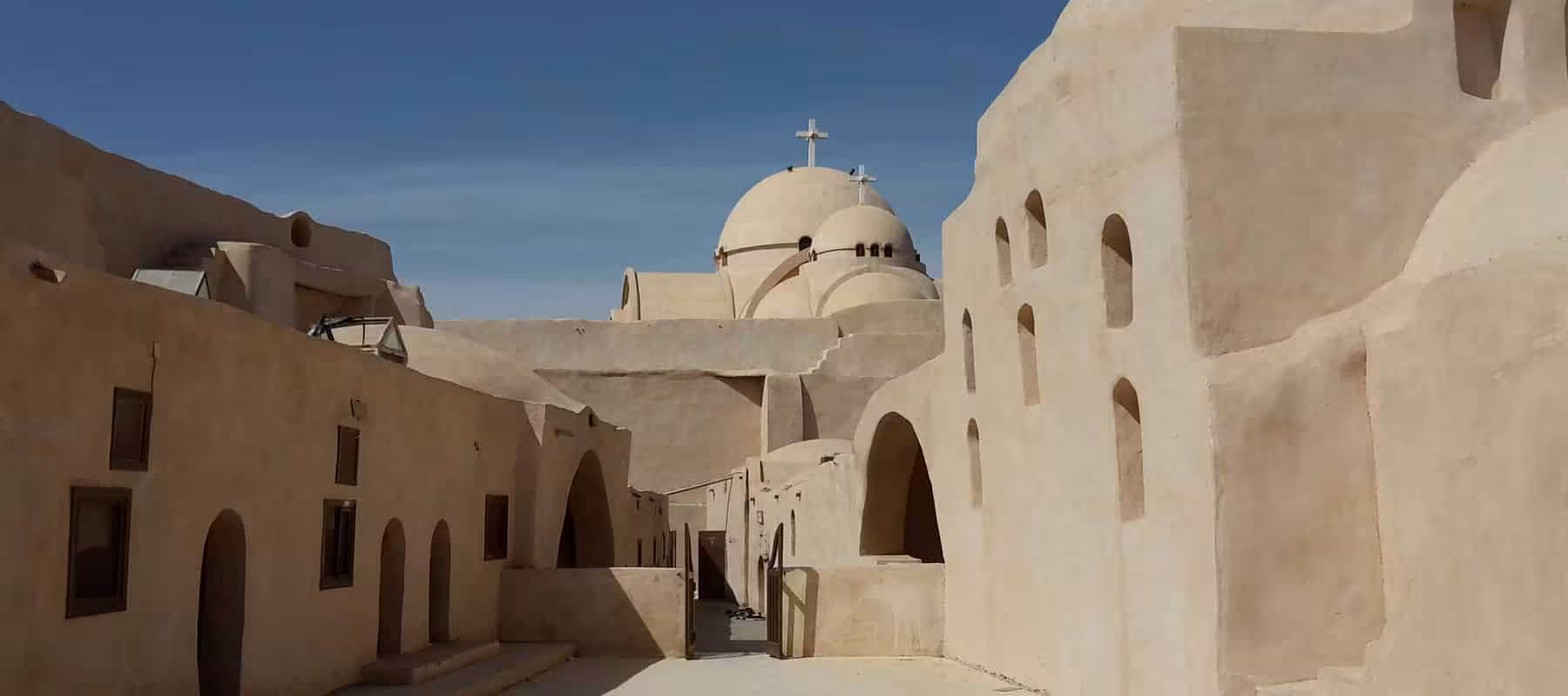White domes and arches of a Coptic Cairo church complex, featured on exclusive private Islamic & Coptic tour