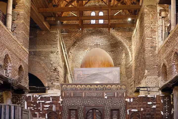 Historic church interior in Coptic Cairo with brick arches and dome, featured on Muizz Street bazaar day tour