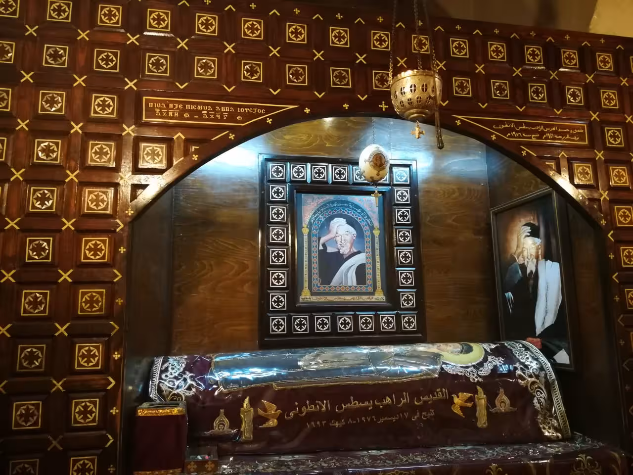 Saint monk Bsatus Al-Antony shrine with ornate Coptic woodwork and portrait in Red Sea monastery