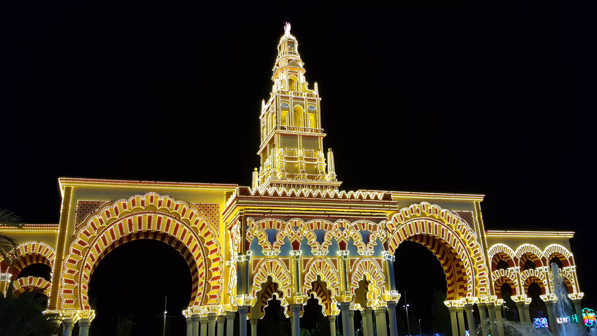 Cordoba fairground gateway lit at night, scenic stop on Cordoba in 1 day walking tour with audioguide