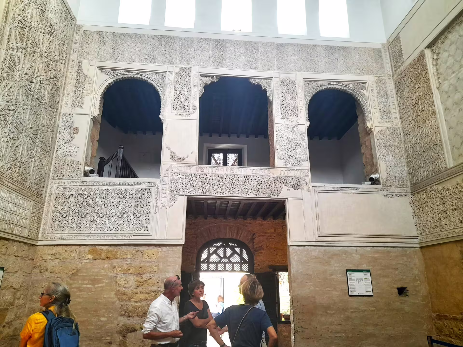Guided Cordoba group walking tour inside Alcazar of the Christian Monarchs, ornate Moorish arches and courtyard