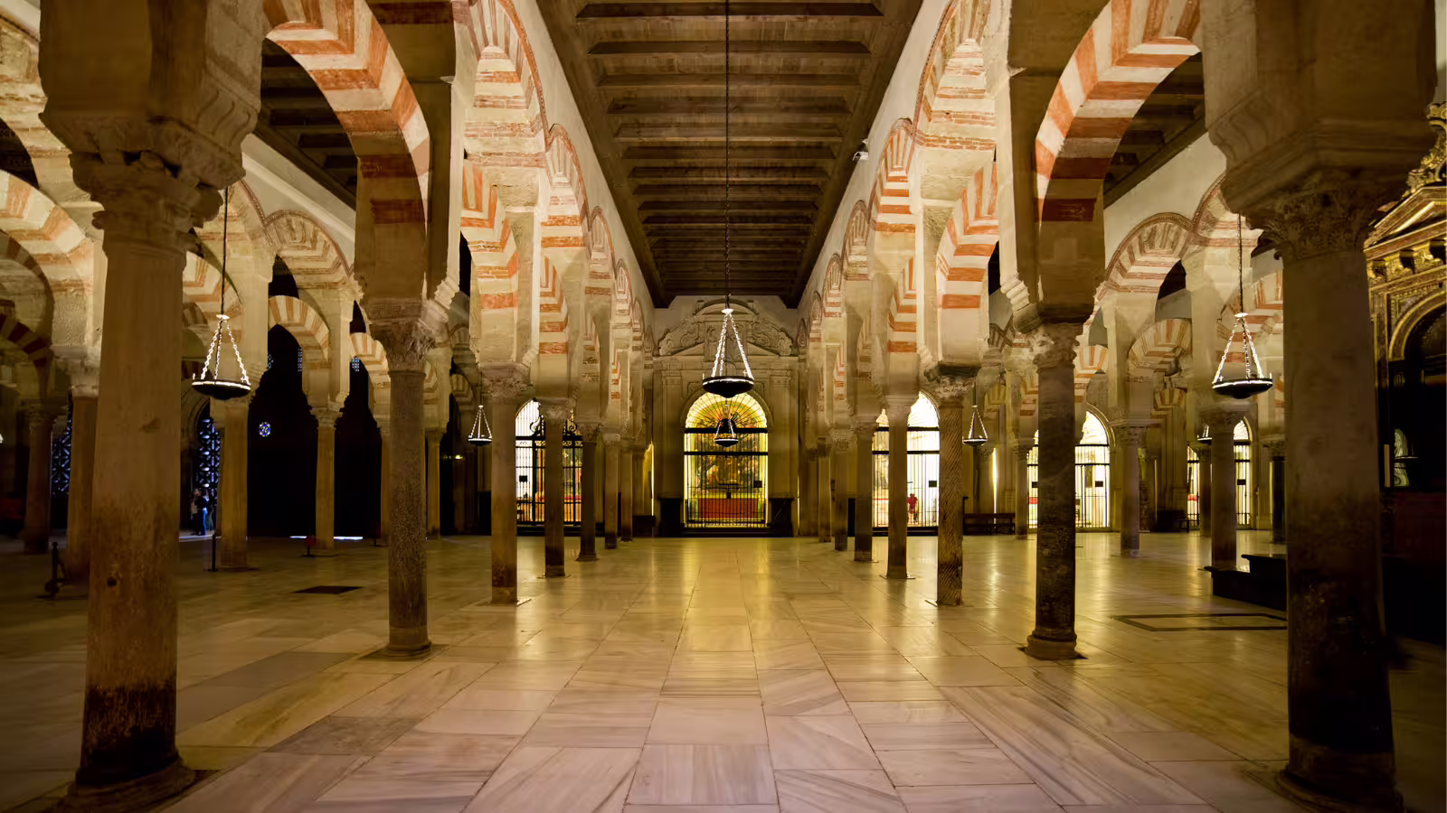 Red-and-white arches and columns of the Mezquita-Catedral interior on a Cordoba private walking tour