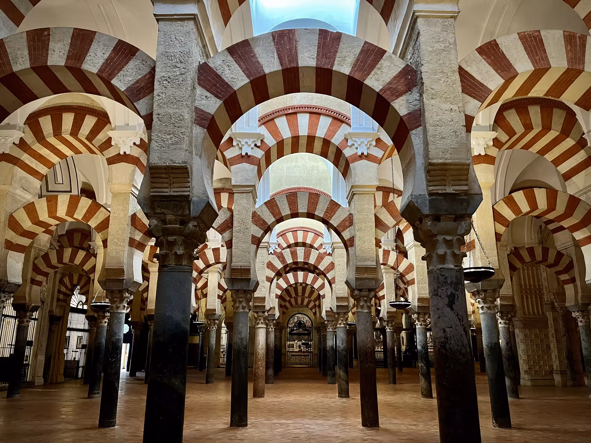 Forest of striped arches and columns in Córdoba Mezquita-Catedral prayer hall on Mezquita monument tour