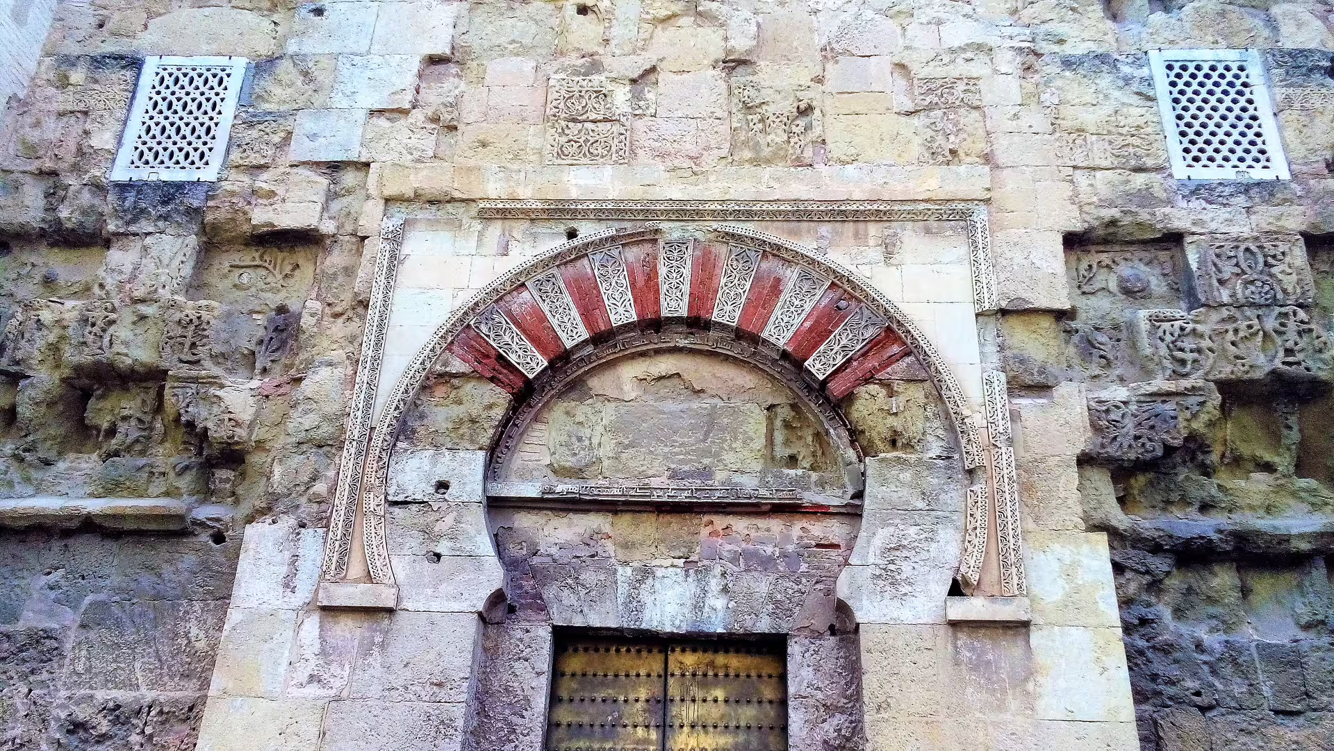Close-up of an ornate Moorish horseshoe arch doorway, a highlight on a Cordoba private walking tour