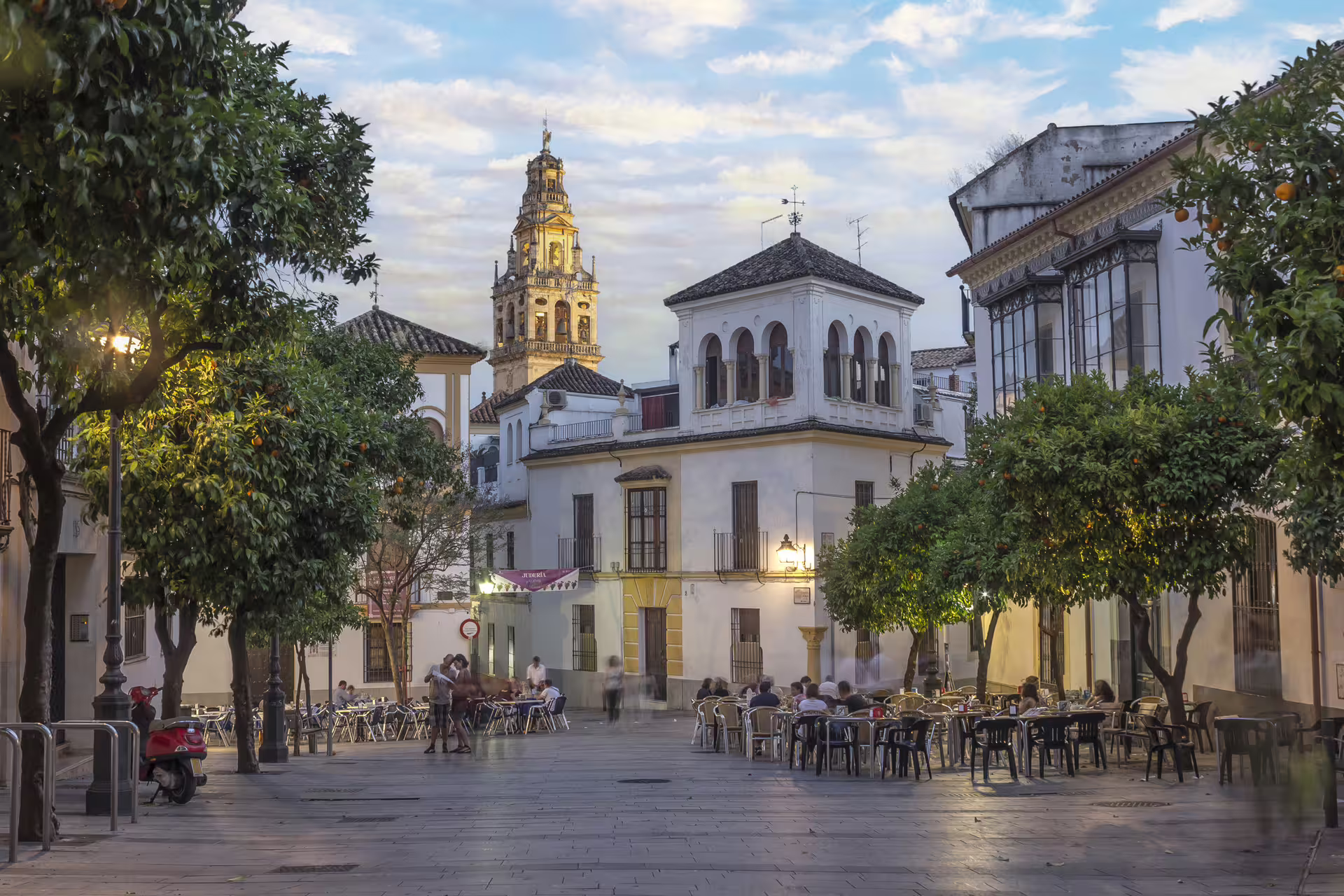 Cordoba old town plaza with orange trees and Mezquita-Cathedral bell tower, ideal 1-day audioguide walk