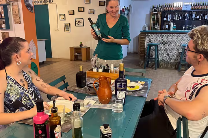 A group enjoying an olive oil tasting session in a Cordoba eatery, emphasizing authentic Spanish flavors.