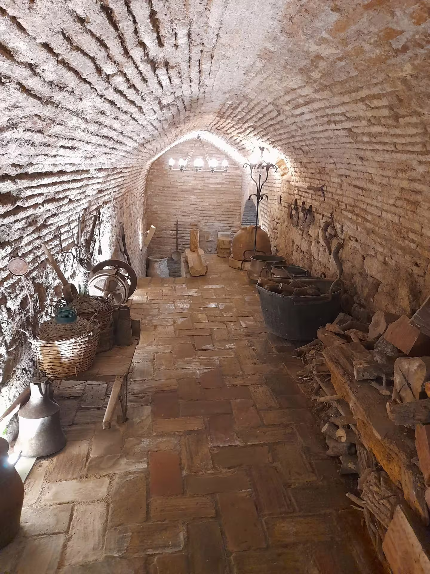 Traditional brick-vaulted cellar in Córdoba with old tools and pottery, stop on a private walking tour