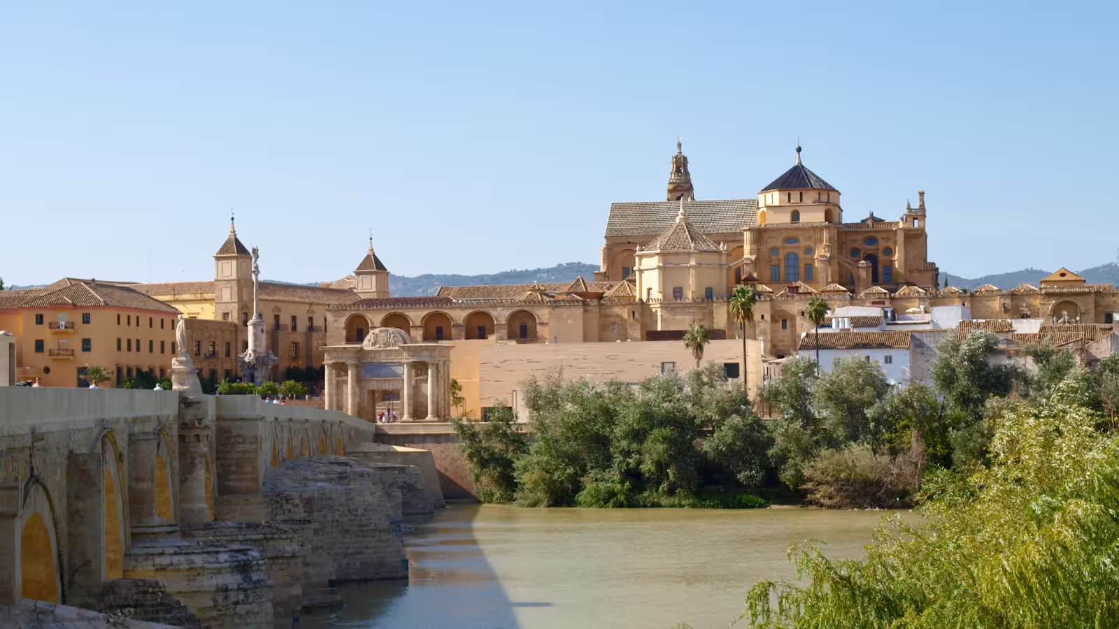 Roman Bridge and Mezquita-Catedral skyline over the Guadalquivir River on a Cordoba group walking tour
