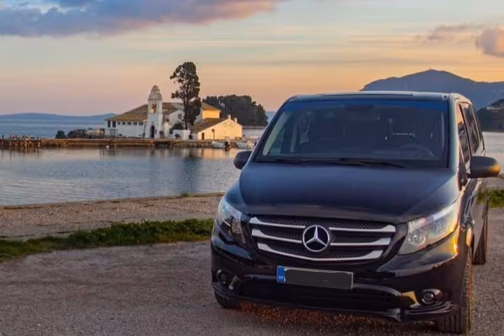 Private Corfu airport and port transfer with luxury van by Kanoni waterfront, comfortable door-to-door service