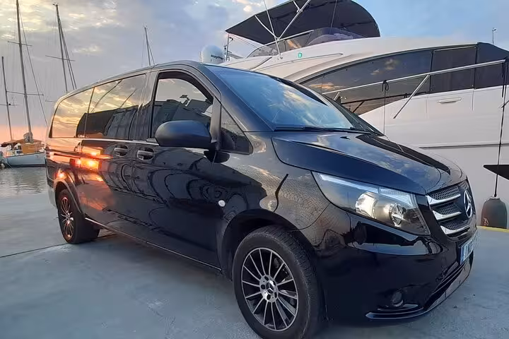 Luxury black Mercedes van at Corfu marina, private transfer from Corfu port or airport with professional driver