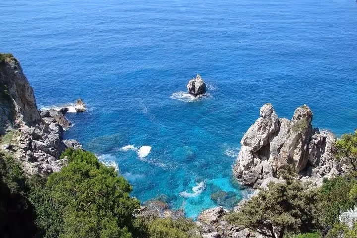 Rugged Corfu coastline with sea stacks and crystal-clear water, Beauty & the Beach private tour view