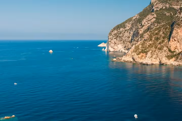 Ionian Sea cliffs on Corfu private tour, panoramic coastal drive with crystal-blue water and sea stacks
