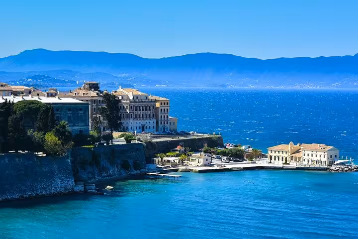 Coastal view of Corfu Town by the Ionian Sea with historic buildings, featured on the 4-hour group tour