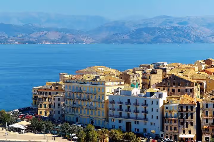 Corfu Town waterfront with Venetian-style buildings and Ionian Sea backdrop, explored on private tour with local tastings