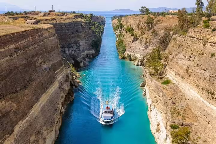 Boat cruising through the Corinth Canal, scenic photo stop on Athens Highlights & Ancient Corinth private day tour