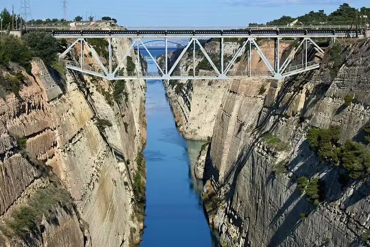 View of the Corinth Canal bridge with its steep cliffs and clear blue waters, a highlight of the Athens private tour.