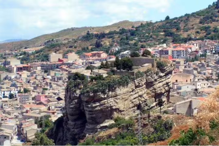 Corleone townscape in Sicily with cliffside rock outcrop, a highlight of the Palermo to Corleone countryside excursion