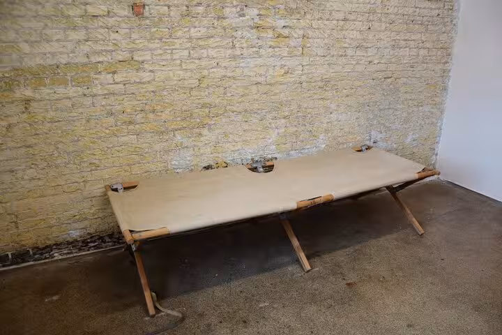 Historic camp-style cot in Corrie ten Boom WW2 experience, illustrating wartime imprisonment and daily life