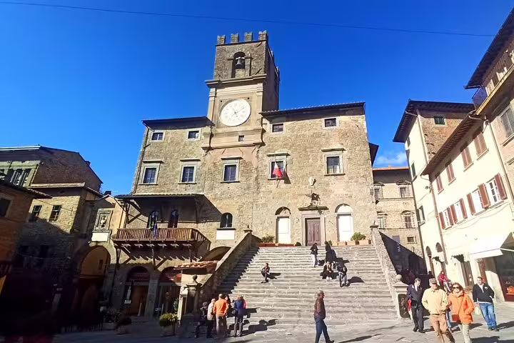 Historic town hall and stone staircase in Cortona’s medieval square, a highlight of the private art and wine tour in Tuscany