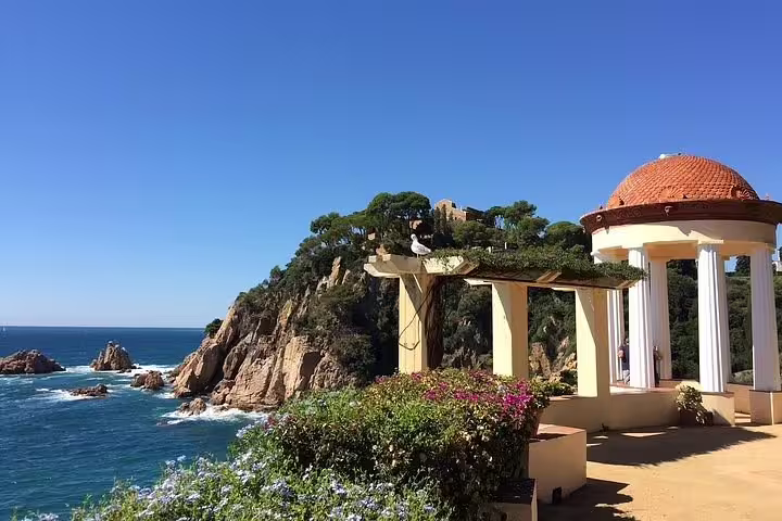 Breathtaking Costa Brava coastal view with Mediterranean sea and picturesque pavilion, a highlight on the Dalí Museum tour.