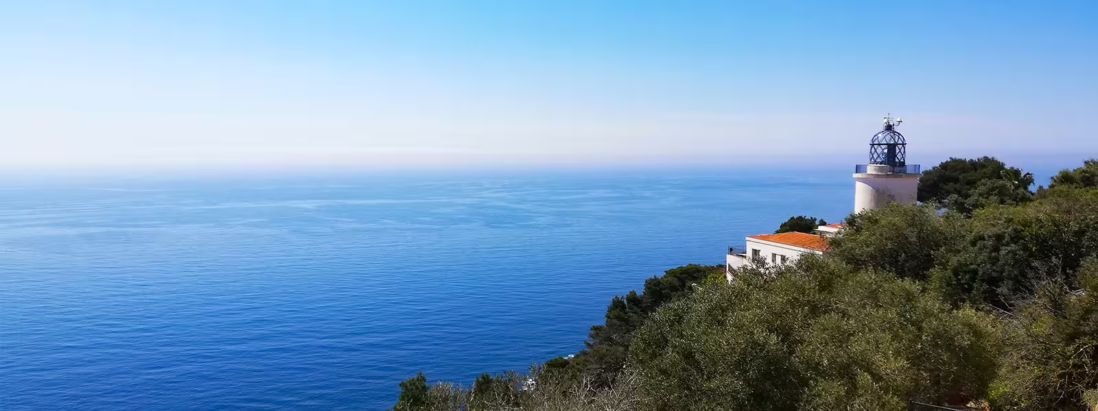 Scenic view of Costa Brava lighthouse with panoramic ocean backdrop, ideal for a relaxing day tour experience.